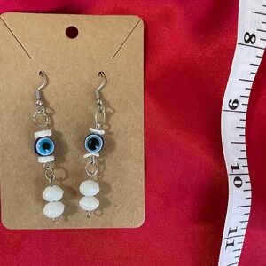 White beaded evil eye earrings
